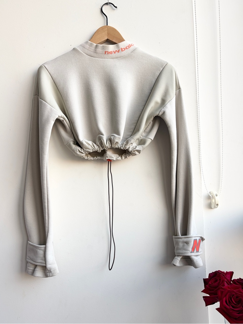 New Balance Women’s Cream Cropped Drawcord Jacket with Coral Logo